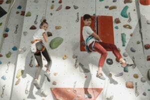 image of two children bouldering | unique fun things to do in boulder colorado with a family music festival