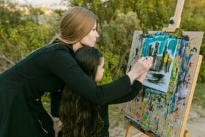 image of a woman painting with a toddler outside | things to do in boulder with toddler family friendly visit boulder colorado